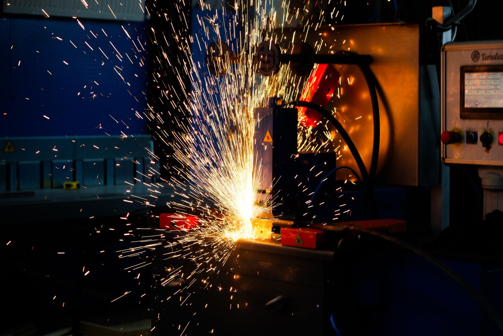 Automated welding station throwing sparks